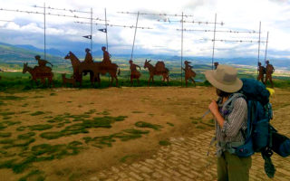Me hiking El Camino de Santiago at an overlook between Pamplona and Puente la Reina, for Ellen Blazer's travel blog To Travel and Bloom
