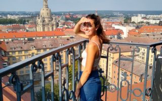 Ellen looking over Dresden, Germany from the bell tower of Kreuzkirche Cathedral, for Ellen Blazer's travel blog To Travel and Bloom